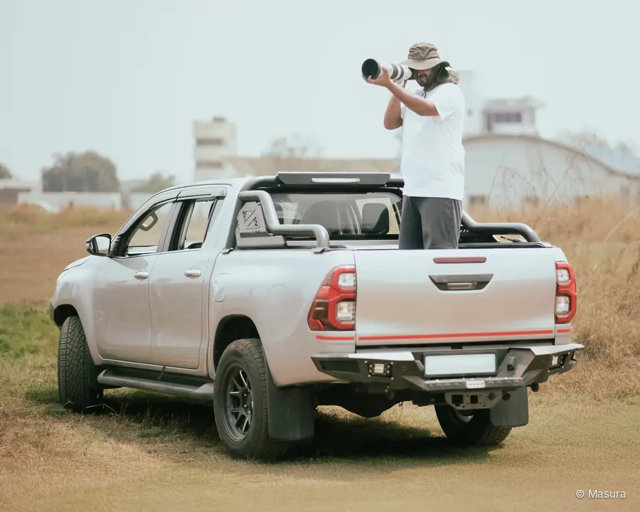 Pramukh Bajaj photographing from the back of a pickup truck